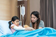 © ronnachaipark - asian girl with a broken arm wearing a cast on the hospital bed with her mother