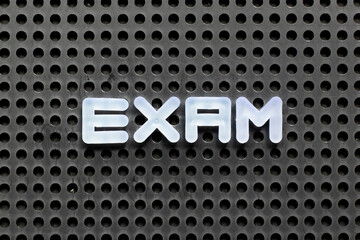 Sticker - White color letter in word exam on black pegboard background