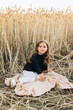 © Максим Галінский - Little beautiful smiling girl on a gold wheat field. Girls in the grain-field. Cute little girl in the summer field of wheat.