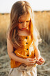 © Максим Галінский - Little beautiful smiling girl on a gold wheat field. Girls in the grain-field. Cute little girl in the summer field of wheat.
