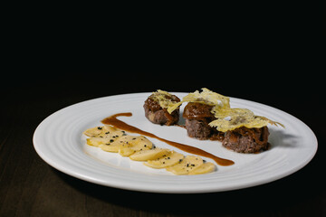 A close-up of a plate with the classic Spanish dish Rabo de Toro.  Bull's tail haute cuisine main course plate.