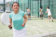 © JackF - Emotional young adult woman training padel at warm sunny day
