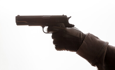 Gloved hand holding a pistol isolated on white background,