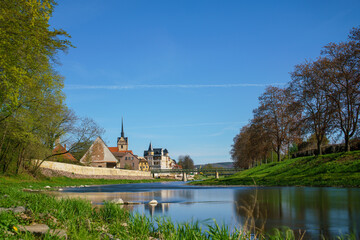 Wall Mural - medieval castle by the river in a small European town