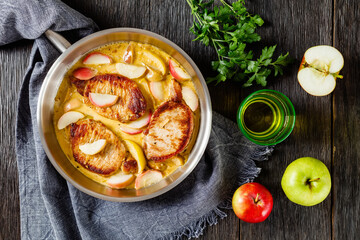 Wall Mural - pork chops in apple cider cream sauce in a pan