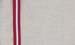 Composition of national latvian patterned ribbon flag on linen fabric