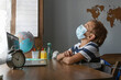 © Anna - Boy in medical mask during on line distant lesson, not paying attention to what teacher is saying. Student is not involved into studying process.
