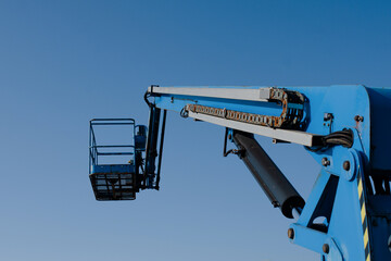 Wall Mural - Telescopic boom lift on blue sky background delivered to constraction site