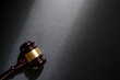 Judge's gavel on black leathe background, top view. Law concept.