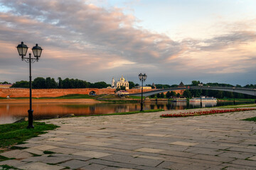 Wall Mural - View of the Sofia Embankment, the Novgorod Kremlin and the Humpback Bridge from the opposite bank of the Volkhov River on an early cloudy summer morning, Veliky Novgorod, Novgorod Region, Russia