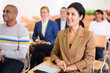 © JackF - Young woman entrepreneur attending seminar with colleagues in board room