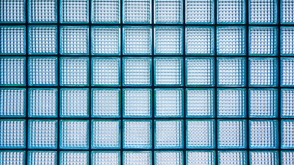 Square pattern of glass block wall background, view from inside room