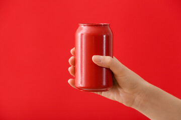 Wall Mural - Hand with can of soda on color background