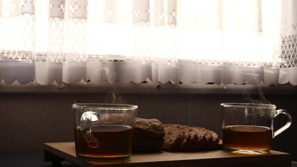 Sticker - Preparing breakfast meal in caravan rv interior. Two hot steaming tea cups and sliced bread on table. Holiday trip in motor home. Camper car vacation travel.