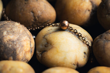 Close-up brass jewelry on river gravel background.Vintage necklace,ancient jewelry,used for vintage background