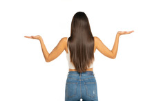 Rear View Of A Young Beautiful Woman Holding Imaginary Objects In Her Arms