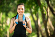 © mnirat - middle-aged Beautiful Sport Asian woman outdoor walking in park smiling living an active and healthy lifestyle.