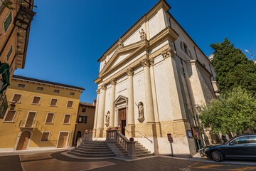 Wall Mural - Facade of the parish church of the Saints Zenone and Martino in Neoclassical style, 1888, of the small village of Lazise, tourist resort on the coast of Lake Garda, Verona, Veneto, Italy, Europe.