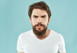 © SHOTPRIME STUDIO - bearded man in a white t-shirt hand gestures anger close-up