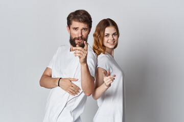 cheerful men and women are standing side by side in white t-shirts fashion design studio