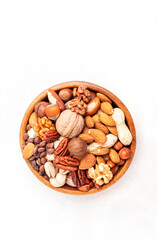 Wall Mural - Nut mix in bowl. Almonds, hazelnuts, walnuts and other. Healthy food snack mix on white table, top view, copy space