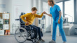 Hospital Physical Therapy: Determined Young Man with Injury Successfully Stands up from Wheelchair and Walks with Help of Rehabilitation Physiotherapist. Willpower, Grit, Strong Mindedness.
