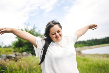 Wall Mural - Portrait of trisomy adult outside having fun with freedom arm high