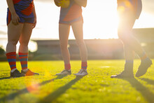 Legs Of Three Female Footballers Backlit With Sun Flare