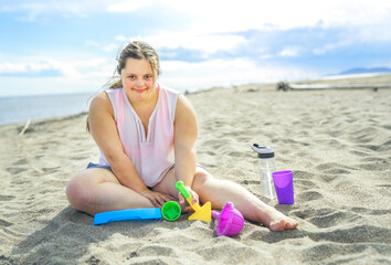 Wall Mural - Trisomy 21 woman having fun at the beach