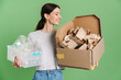 © Drobot Dean - Young brunette woman posing with plastic and paper waste