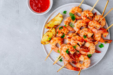 Wall Mural - Grilled Lemon Shrimp Skewers in plate on gray stone background.