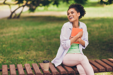 Sticker - Photo of happy dream positive dark skin woman look hold hug book smile outdoors outside college park