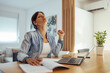 © bnenin - Tired woman working in home office.