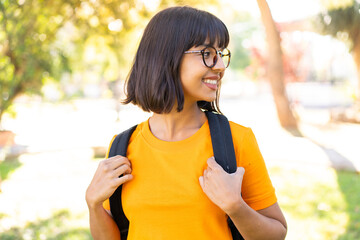 Wall Mural - Young brunette woman at outdoors with happy expression