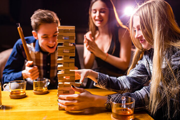 Young people have fun playing board games at a table