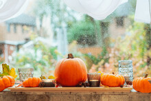 Autumn Cozy Mood Composition On The Windowsill. Pumpkins, Candles, Dried Leaves On The Wooden Tray Against A Rainy Window. Thanksgiving, Fall, Hygge Home, Natural Decor. Selective Focus. Copy Space