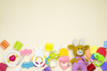 Wall Mural - A lot of children's multi-colored toys are scattered on a beige background. The concept of a child's play. Background from toys. Top view, copy space.