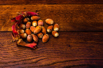 Sticker - Top view closeup of fresh ripe hazelnuts on a wooden table