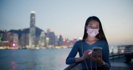 Poster - Woman wear face mask and use of mobile phone in Hong Kong city