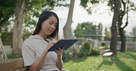 Poster - Woman sketch on tablet computer at park