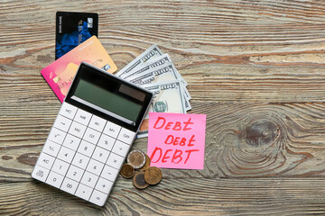 Poster - Paper with word DEBT, money and calculator on wooden background