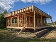 construction of a timber frame house. frame of a private residential building with a window and without walls