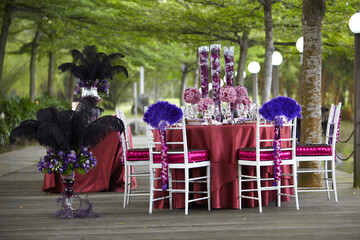 luxury wedding rom banquet sit down buffet party catering in pink purple rose color flower and black feather decoration with fusion halal menu at outdoor beautiful garden