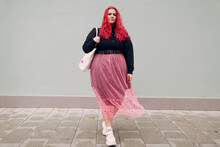 Plus Size Overweight Fat Body Positive Lgbtq Woman Walking Forward With Red Hair And Pink Glasses.
