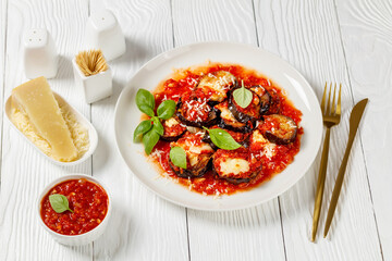 Poster - eggplant parmigiana on a white plate, top view