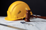 Fototapeta Mapy - Wooden gavel with yellow helmet. Construction law concept