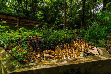 Ancient buddha figures Wat Umong Suan Puthatham is a Buddhist temple in the historic centre and is a Buddhist temple is a major tourist attraction with green forest nature in Chiang Mai,Thailand.