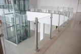 Fototapeta  - Modern glass elevator and glass railings