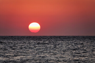 Wall Mural - A great view of the sun over the sea on the island at sunset