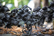 forged acanthus on the historic Catholic cemetery in Warsaw, in the background blurred background with green tree crowns and old dried leaves